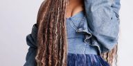 Tasha Cobbs Leonard posing in a blue denim outfit ahead of her TASHA Unscripted live album